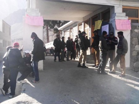 Youngsters and elders staging a sit-in in front of the AC office in Aliabad, Hunza. Placards have been pasted on walls of the office
