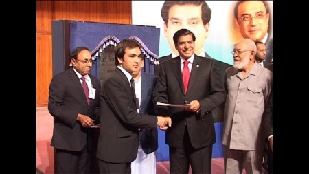 Muhammad Iqbal receiving his prize from the prime minister 