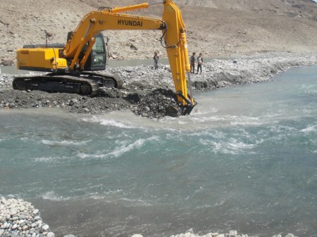 Excavator busy digging the river to divert the flow of water. Photo: Hidayat Shah 