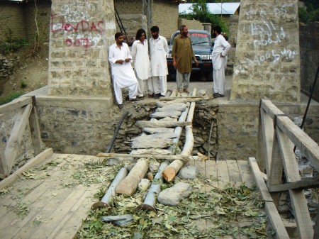 Jughor: Local people trying to re-link a bridge connecting the village with Chitral town 