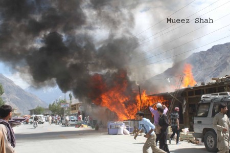 A scene showing local people frantically trying to put off the fire