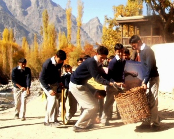 Students collect garbage from a street in the village in Shigar, Skardu (Baltistan)