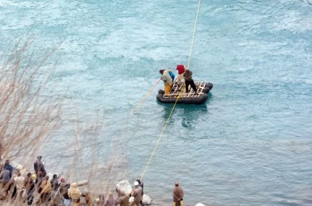 Local volunteers search for bodies in the icy cold Ghizer River. PT Photo
