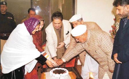 Governor and Chief Minister cutting a cake on the birthday of His Highness the Aga Khan