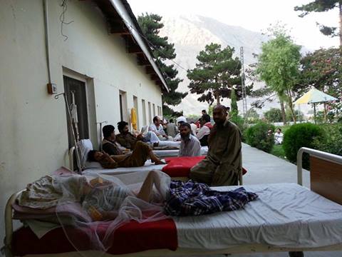 Patients from a ward in District Headquarters Hospital Gilgit have been moved outside, in the open air, due to electricity failure. Photo: M Shah Sumayiri 