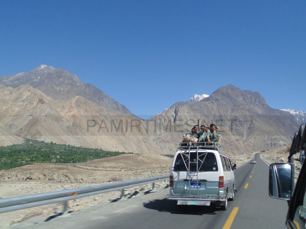 A van moving on the KKH carrying students on its roof. Photo: Javed Karim 