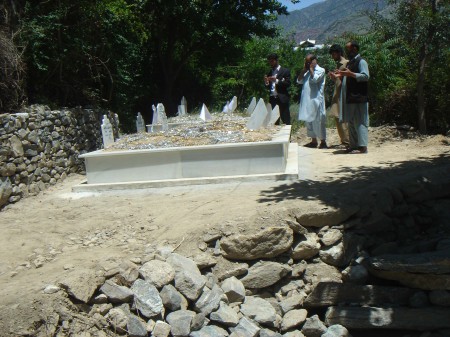 People offering prayers at the grave of the murdered family members 