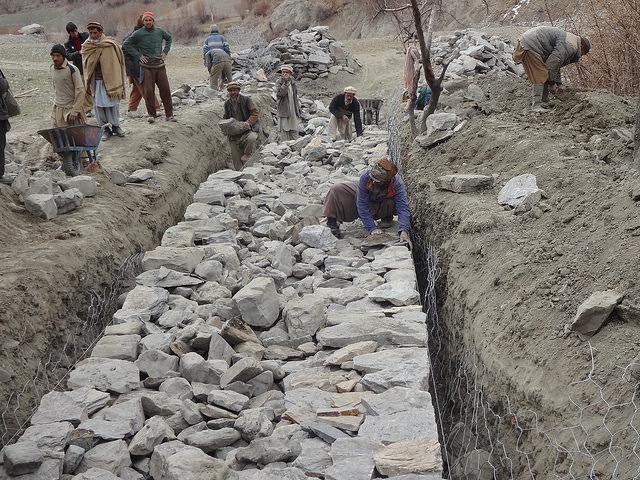 Labourers construct flood-control gabion walls – structures constructed by filling large galvanized steel baskets with rock – in northern Pakistan’s remote Bindo Gol valley. Credit: Saleem Shaikh/IPS