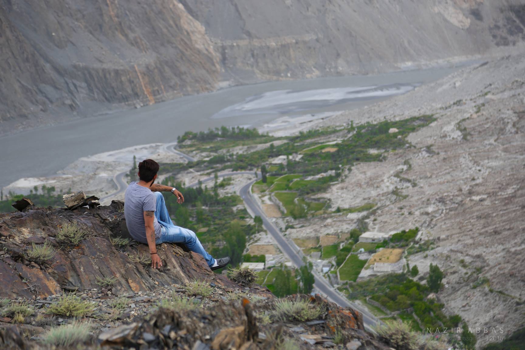 A man looks at the KKH passing through Hussani village of Gojal Valley, Upper Hunza 