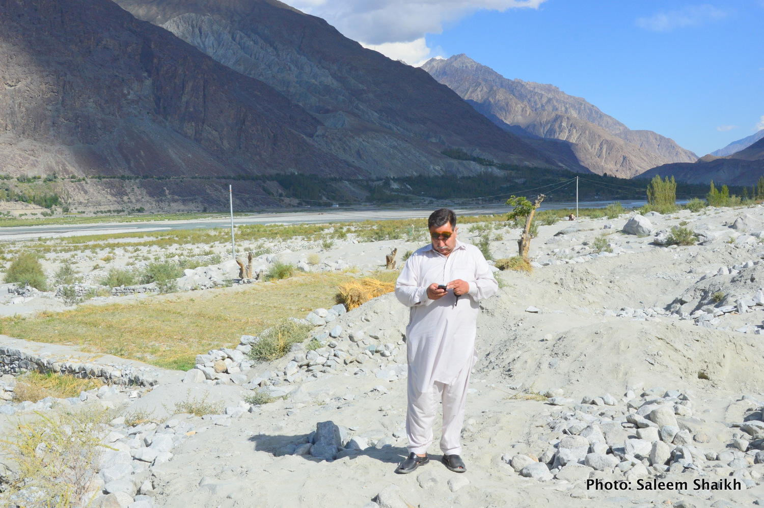 A farmer standing over what were once-fertile maize, potato and what fields now under the mud and heavy boulders washed down by the devastating 2010 flash flood in Damaas valley of Gilgit-Baltistan region’s scenic Ghizer district, Pakistan’s north. Photo credit: Saleem Shaikh