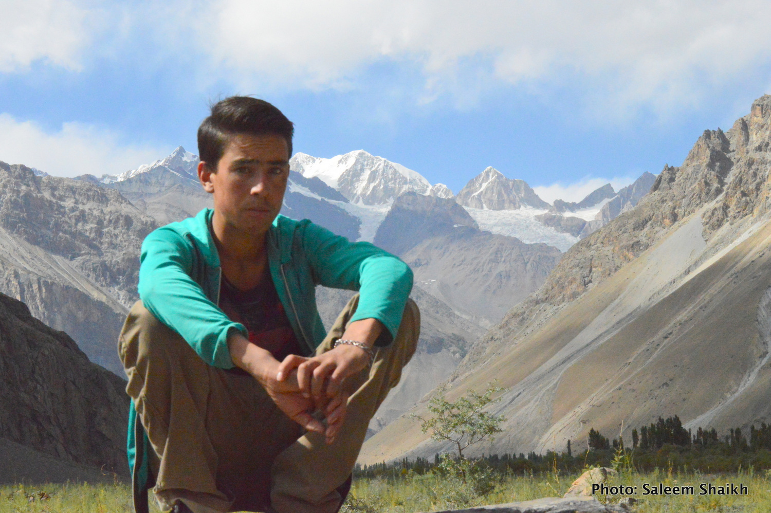 A young boy sits over a big boulder past overlooking Karakoram glaciers in scenic Darkut valley, some 103 miles from Gilgit –capital of Gilgit-Baltistan region. His account paints another grim picture. The devastating flood in 2010 devastating large-scale farm fields and homes, forcing over 100 families to migrat to nearby Ghakuch and Gilgit towns in search of livelihoods. Photo credit: Saleem Shaikh