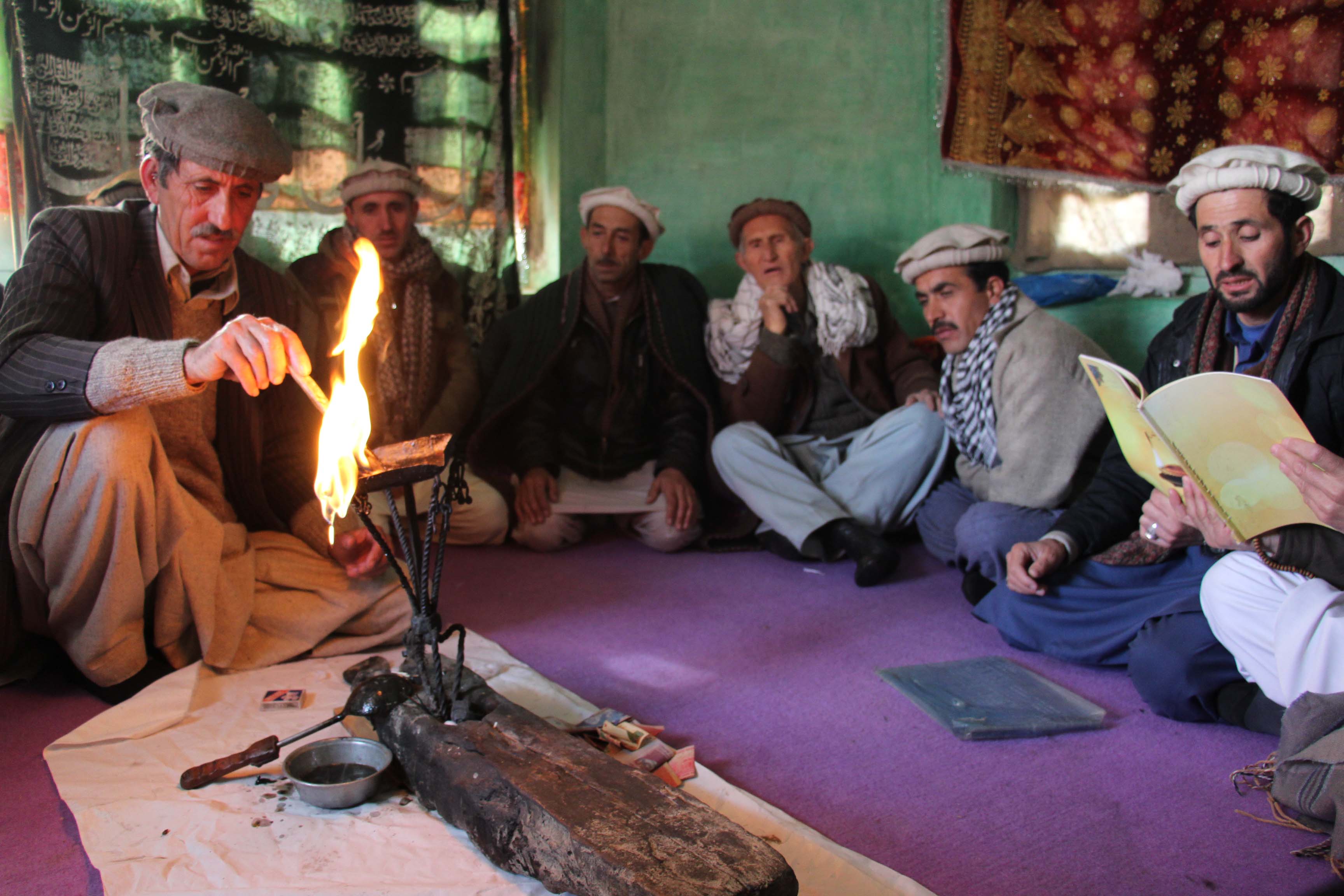 The ritual of Chiragh Roshan is being performed. The lamp is lit and the people recite Salwat 