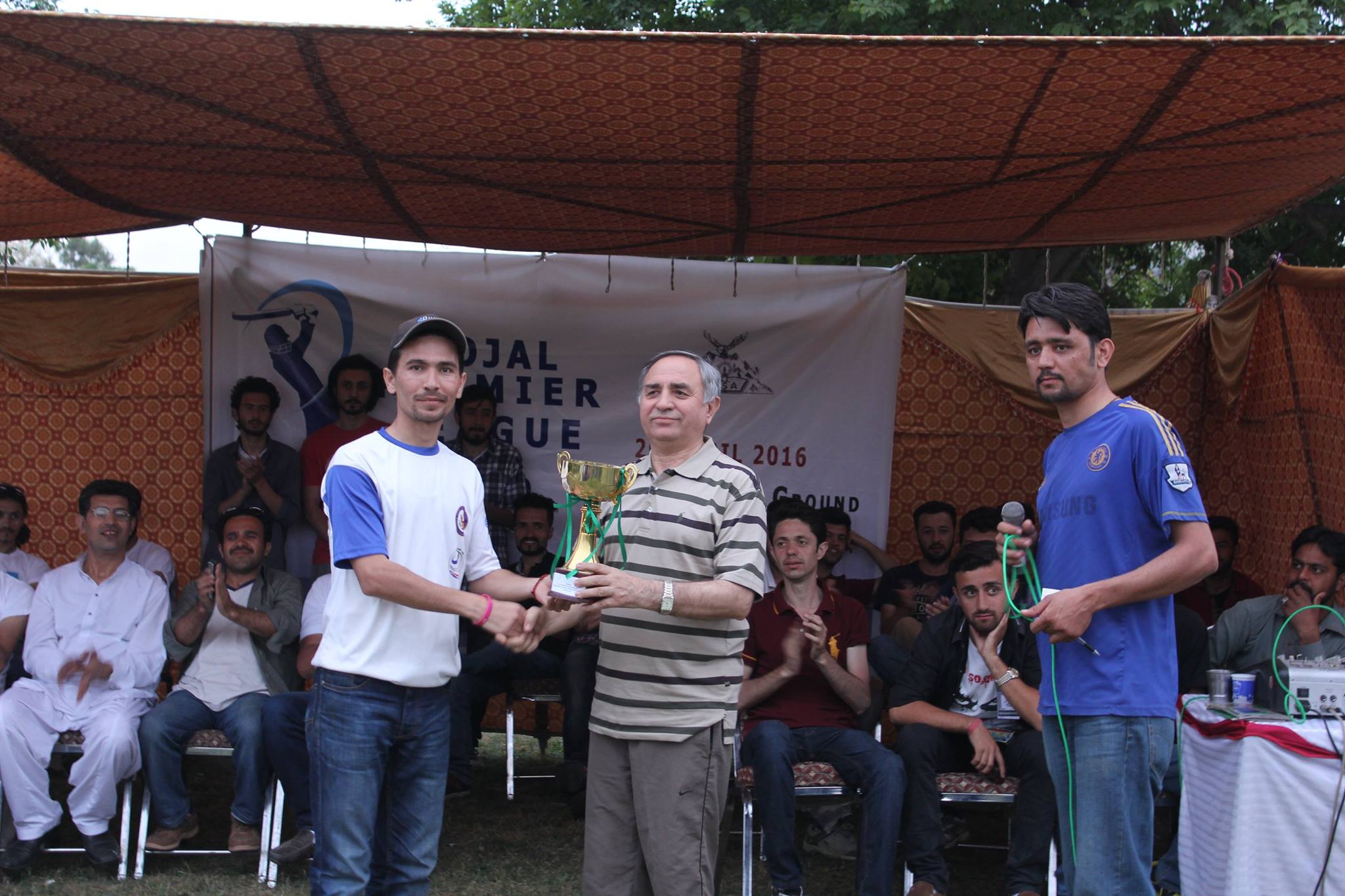Captain Sher Zaman receiving the winning trophy from Mr. Gul Baig 