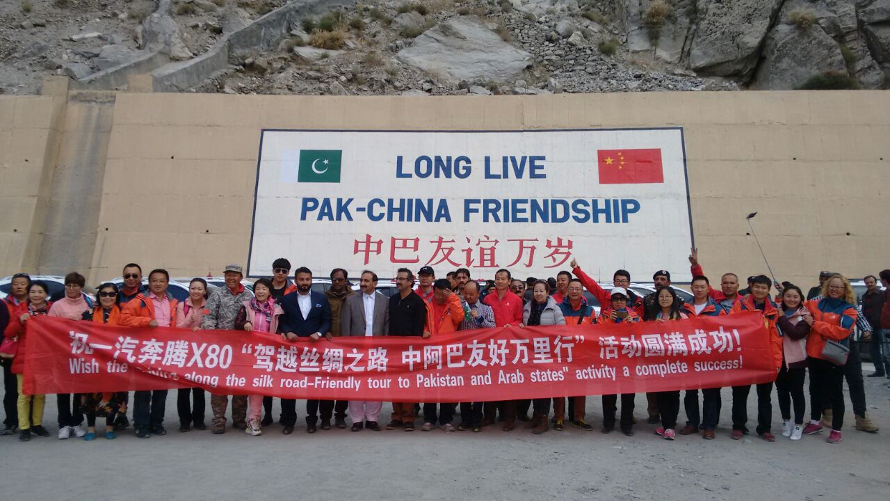 Rally participants pose with the leaders and officials near the Attabad Tunnels 