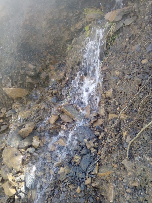 Water cascading down the hill towards the village
